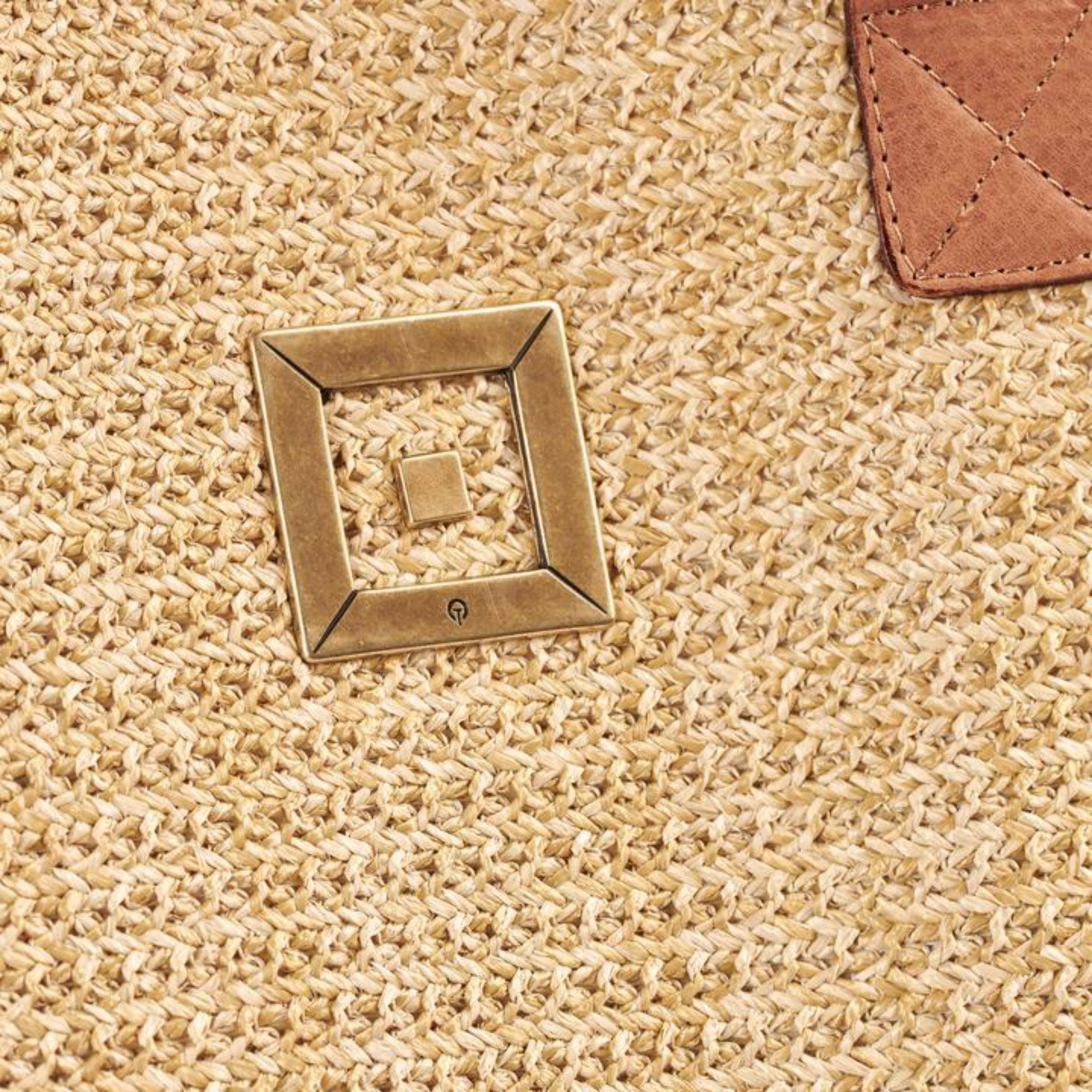 Themis Z handmade straw beach bag with hand weaved leather and metal infinity design.